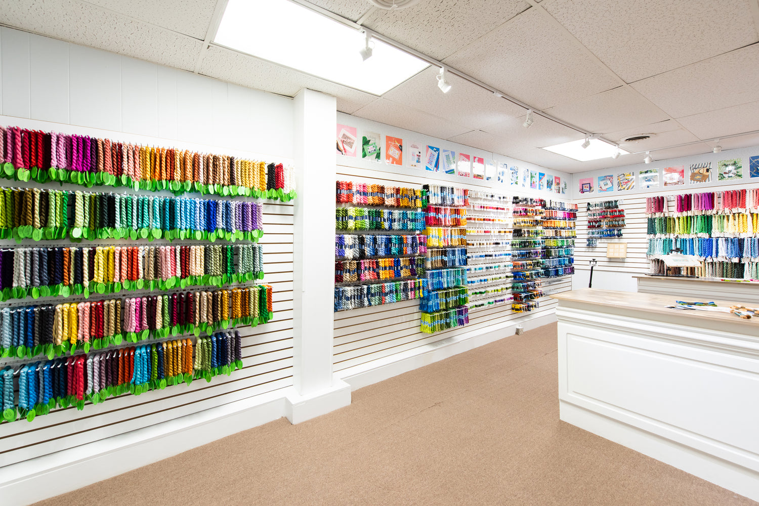 Walls of needlepoint threads in Needlepoint.Com Charleston store