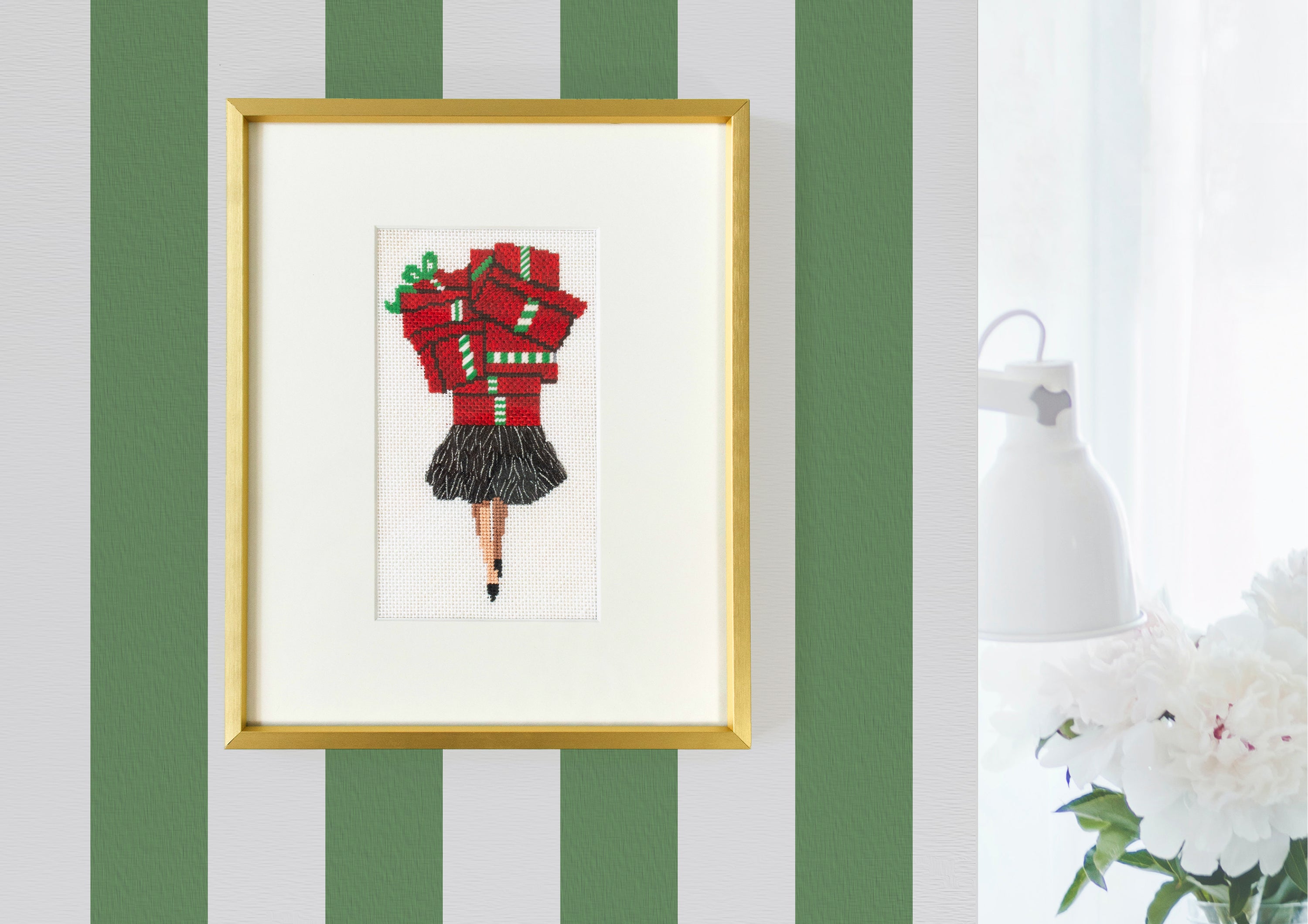 framed finished lady with shopping packages on green and white striped wall